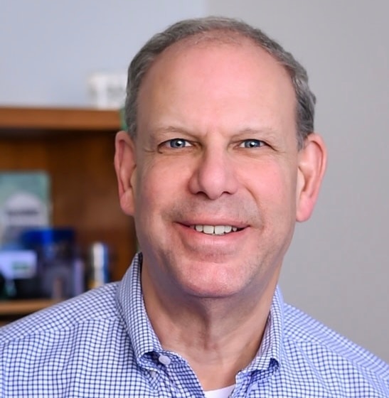 A person wearing a blue shirt and a neck tie.